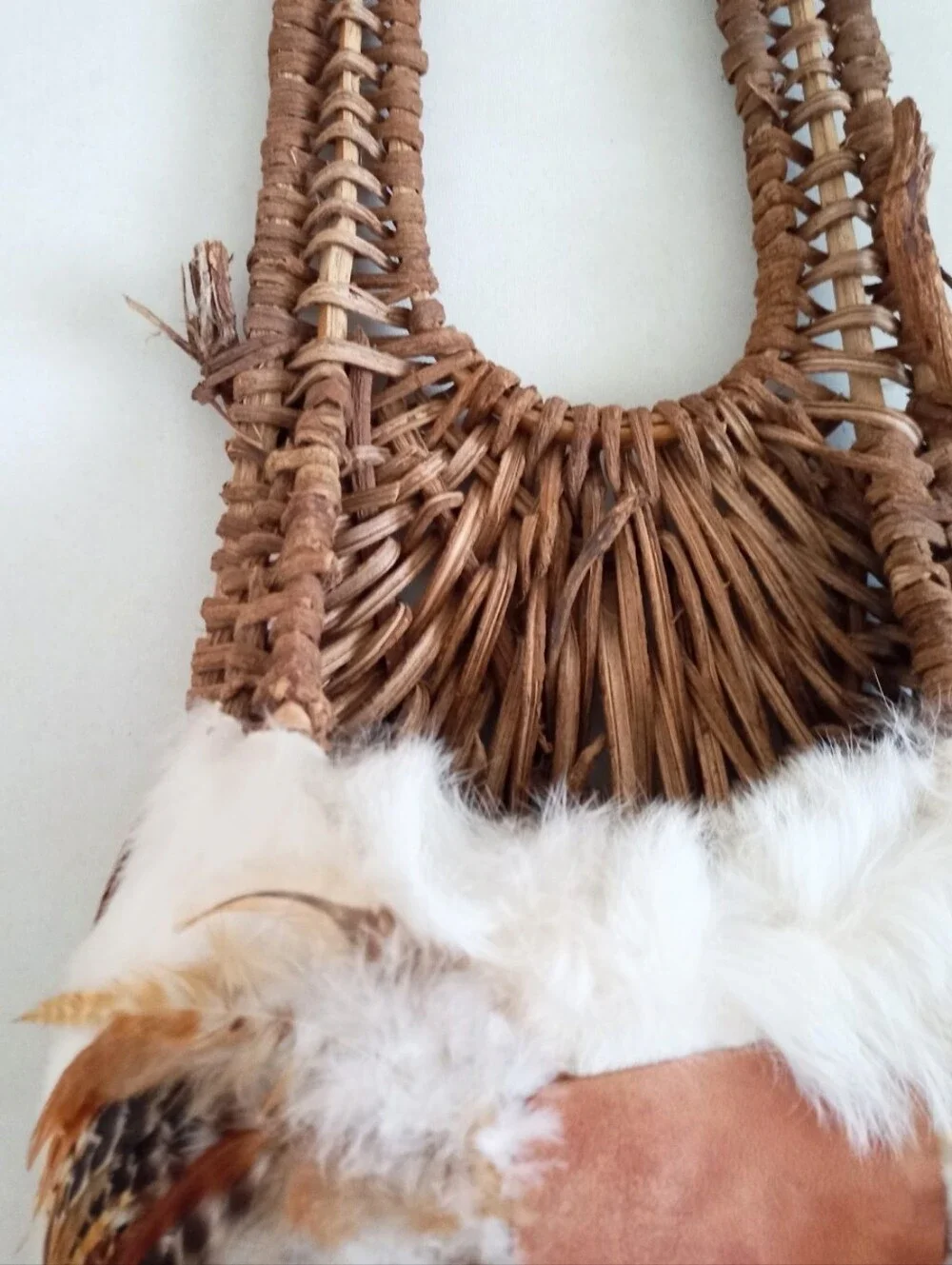 Indigenous Native American vintage natural wicker and feather wall basket